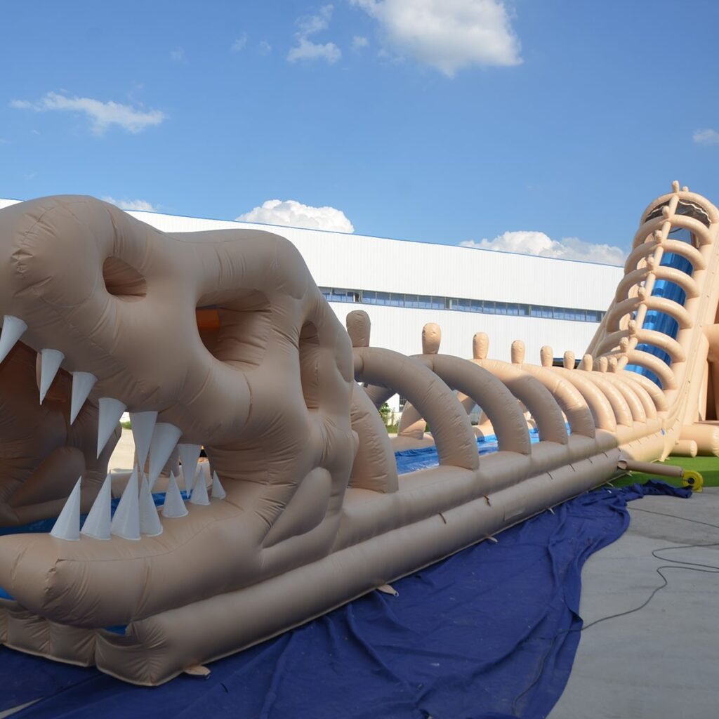 Dinosaur skeleton themed inflatable combo slide at an outdoor event